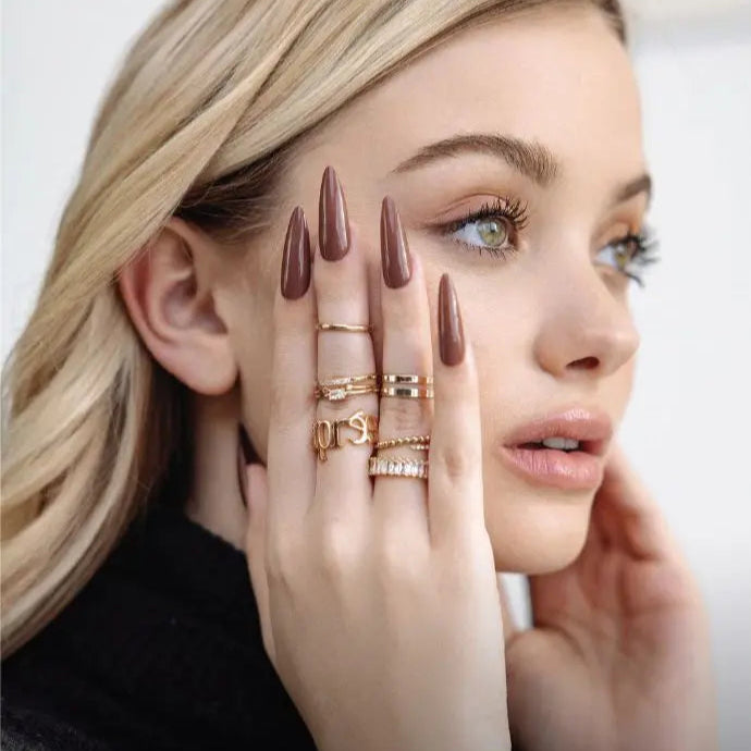 blonde woman brown gel x nails