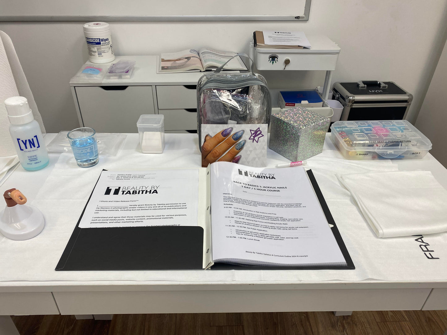 Medical or laboratory workstation with paperwork, supplies, and testing materials laid out on a white surface.