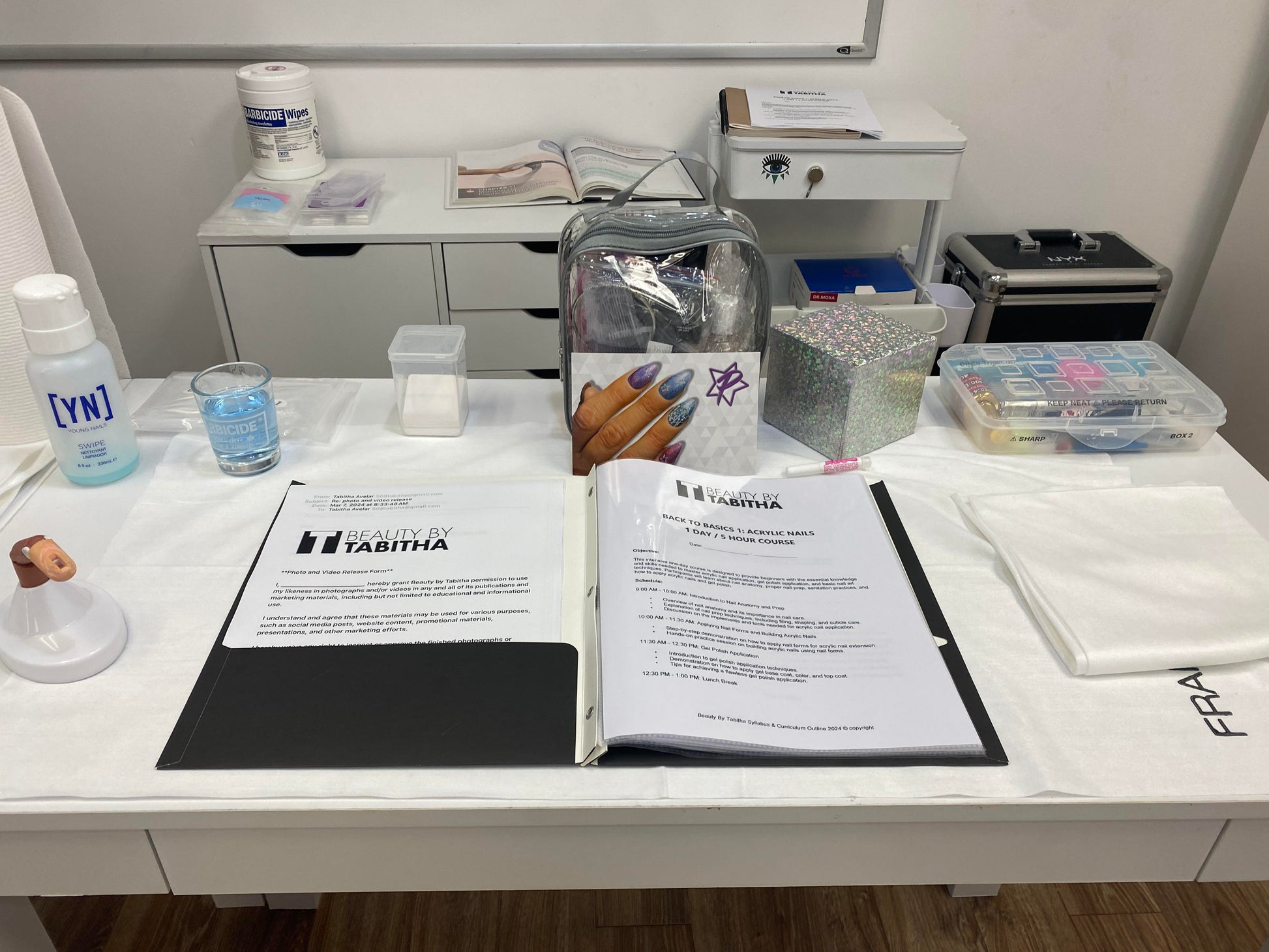 Medical or laboratory workstation with paperwork, supplies, and testing materials laid out on a white surface.