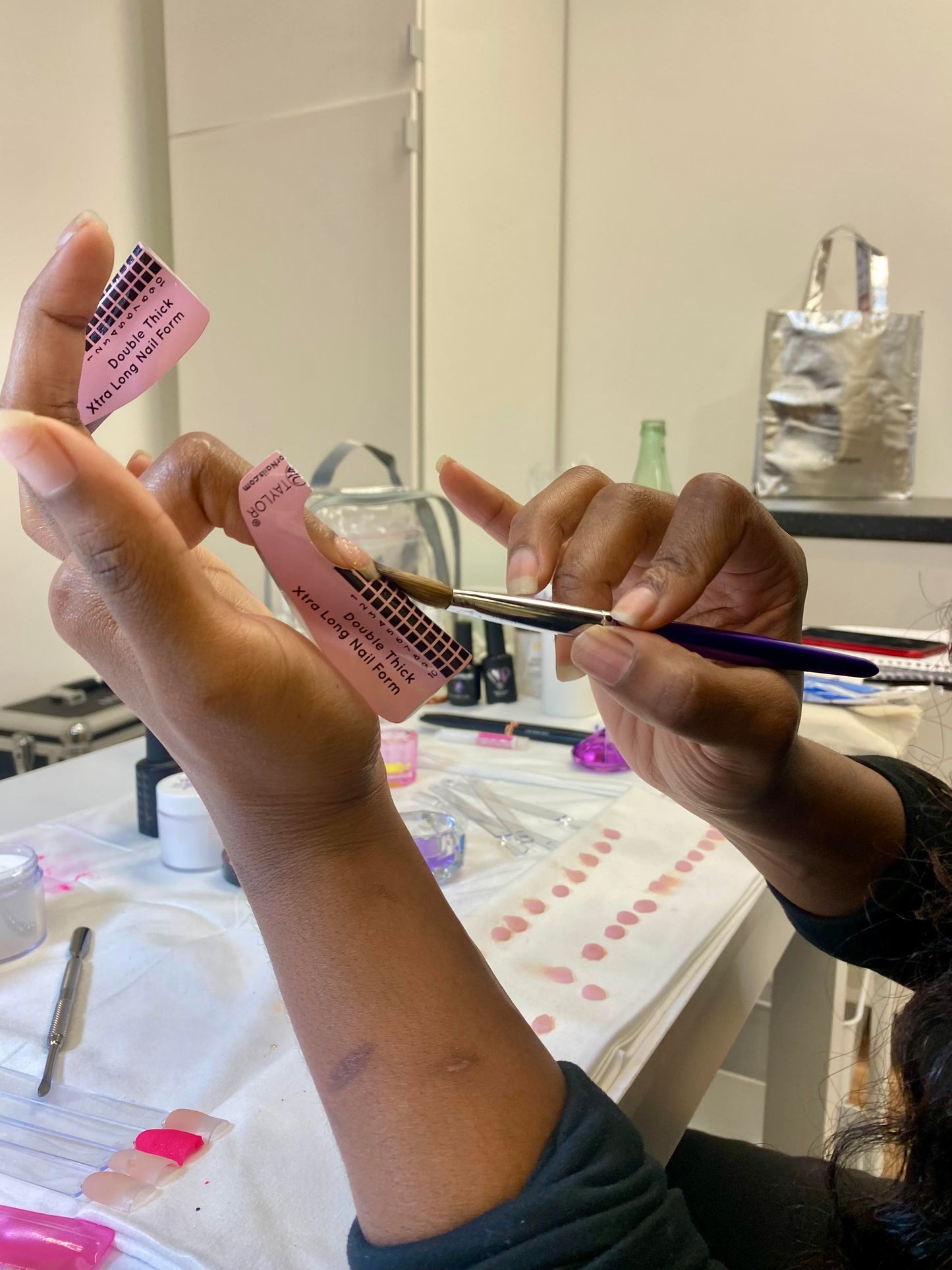 Pink pregnancy test being held in hands.