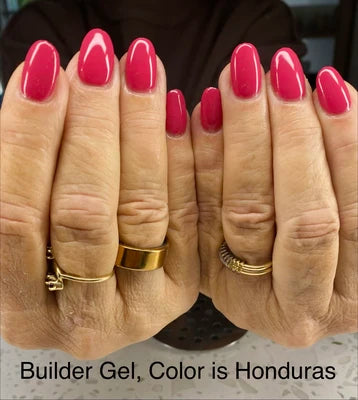 Close-up of hands with pink nail polish and gold rings, Builder Gel Color Honduras text.