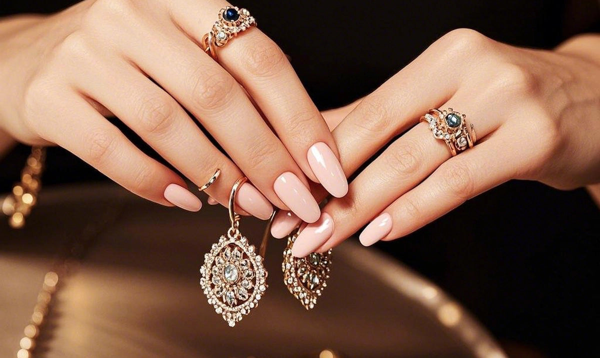 Close-up of hands wearing jewelry with earrings and rings on a dark background